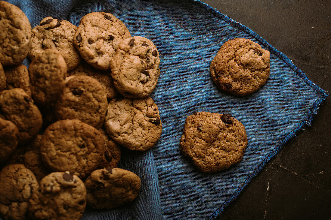From above homemade chocolate chips cookies on a piece of napkin cloth