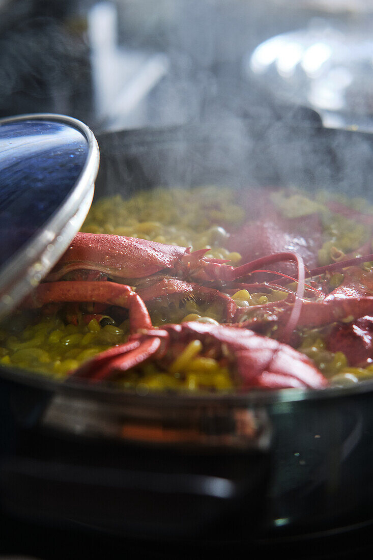 Typical Spanish fideuá with red prawns in cooking pot