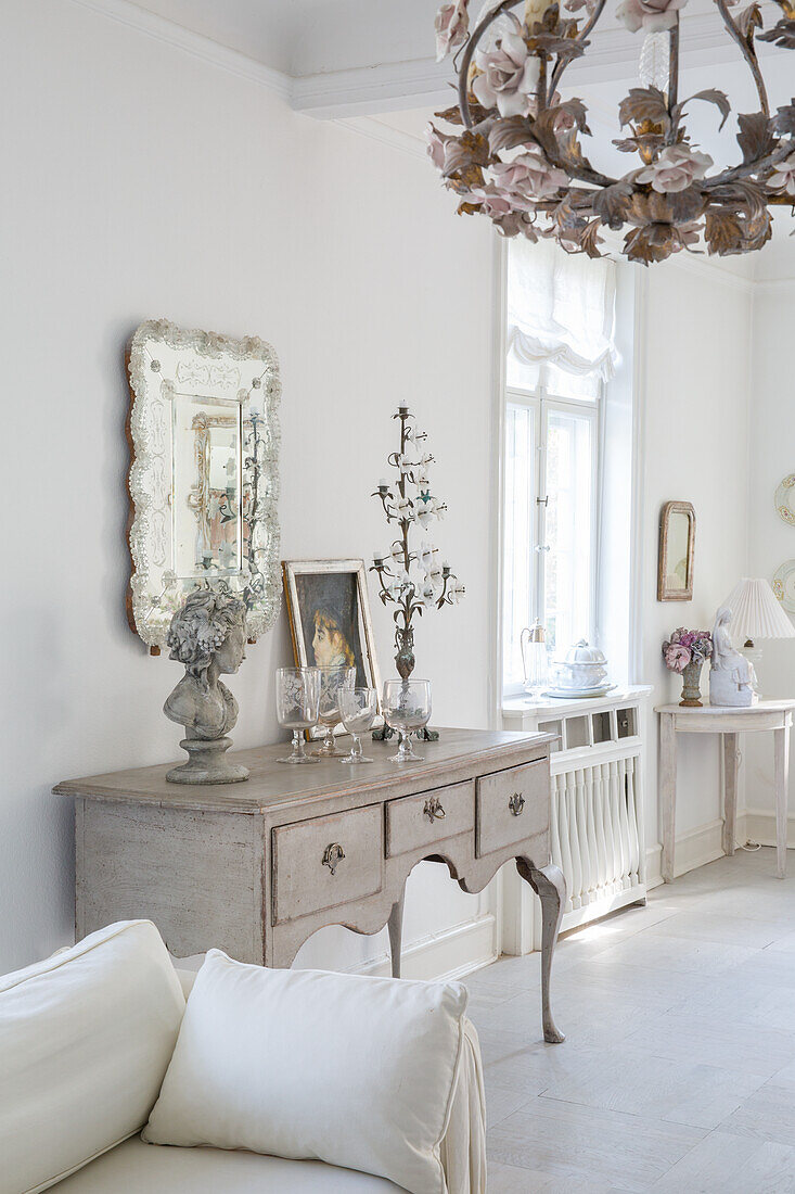 Living room in shabby chic style with antique console table and decoration