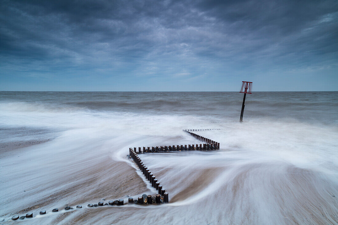 High tide swirling around sea defences