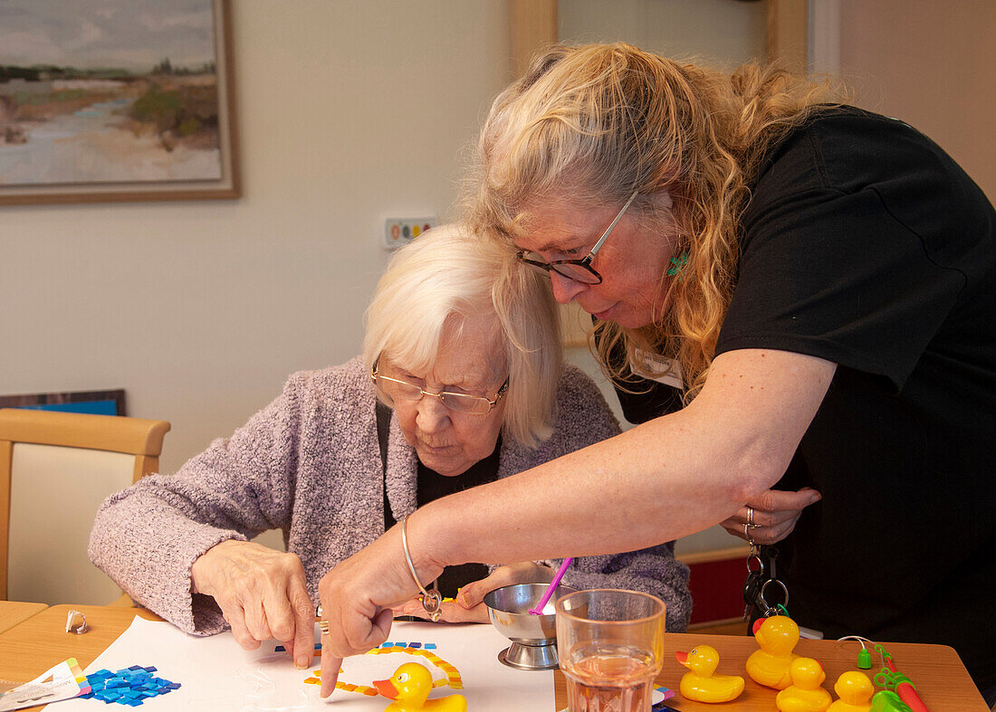 Care home resident taking part in activity