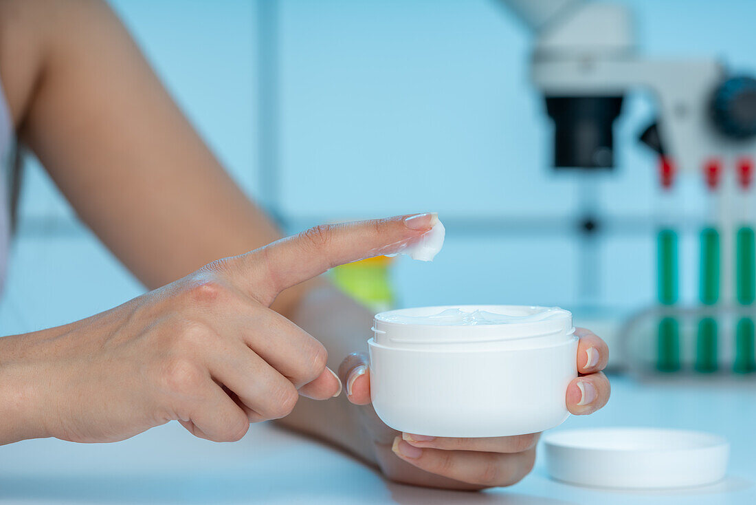 Hands holding jar of cream