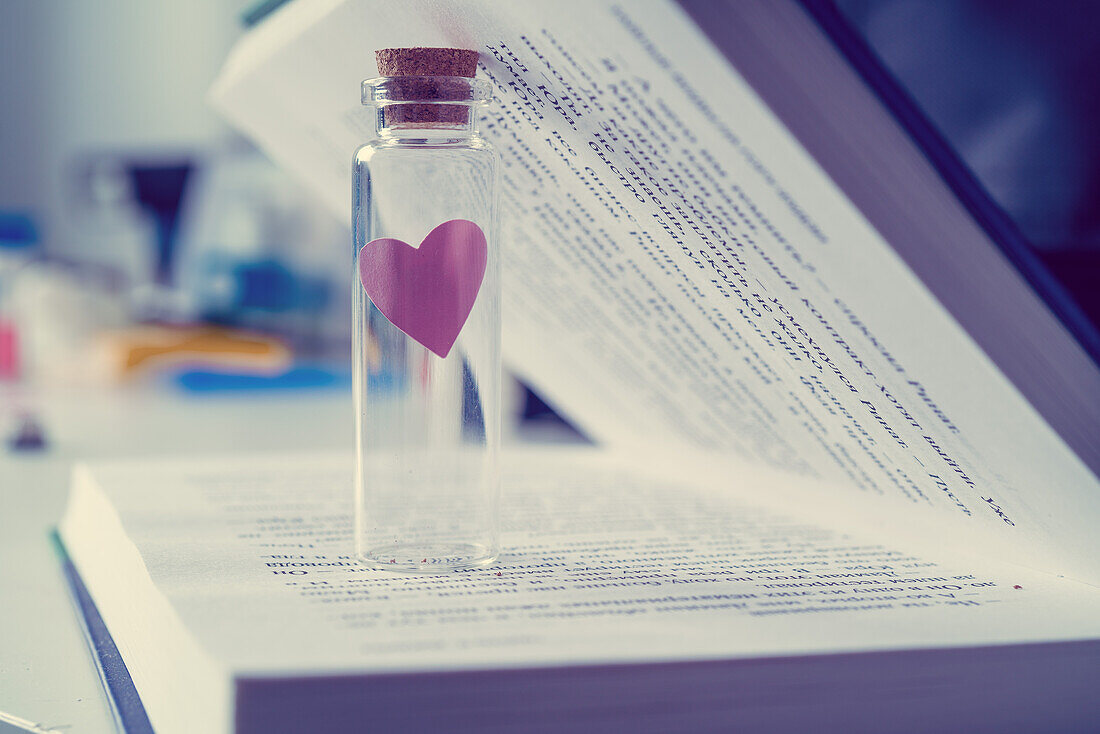 Glass vial with heart inside book