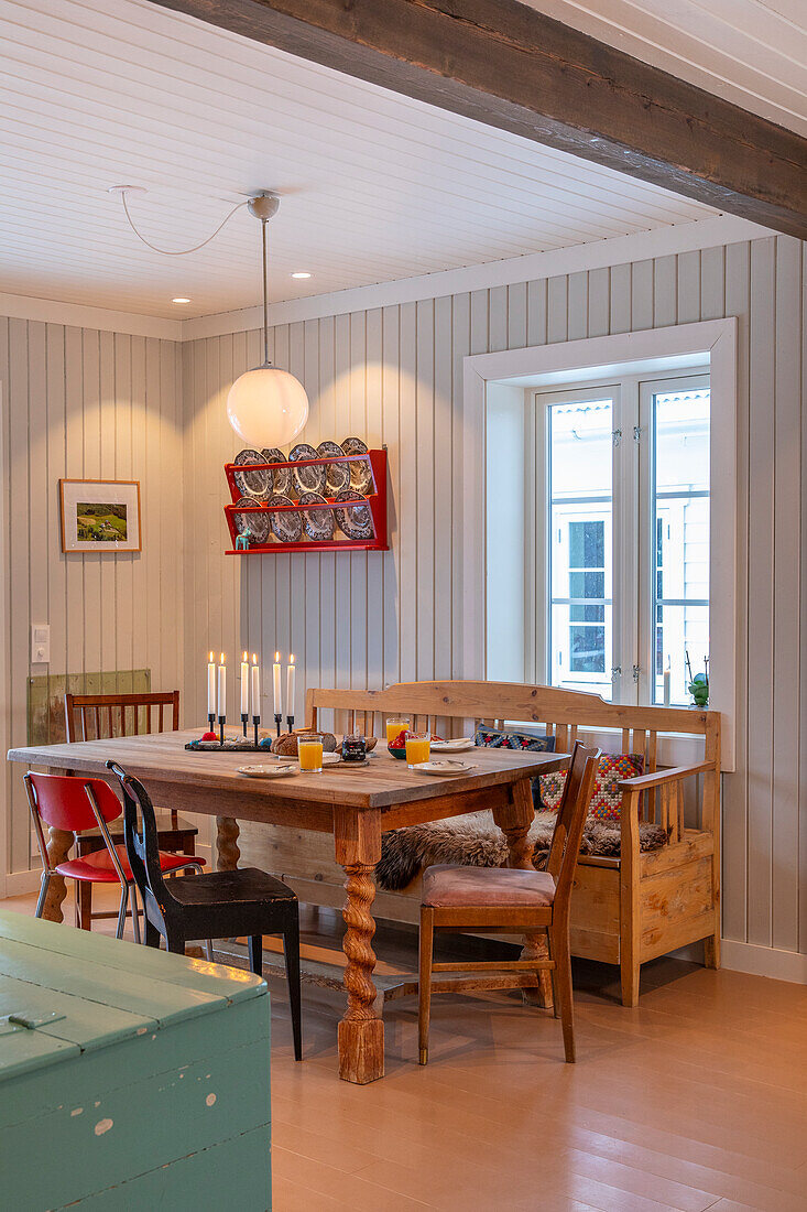 Dining area with wooden table, chairs and rustic country-style bench seat