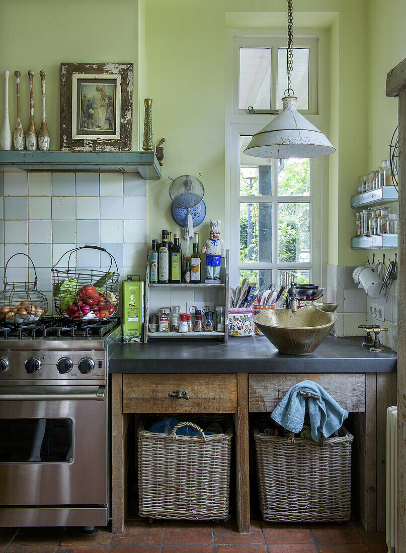 Country-style kitchen with stainless steel stove, rustic wooden furniture and open shelves