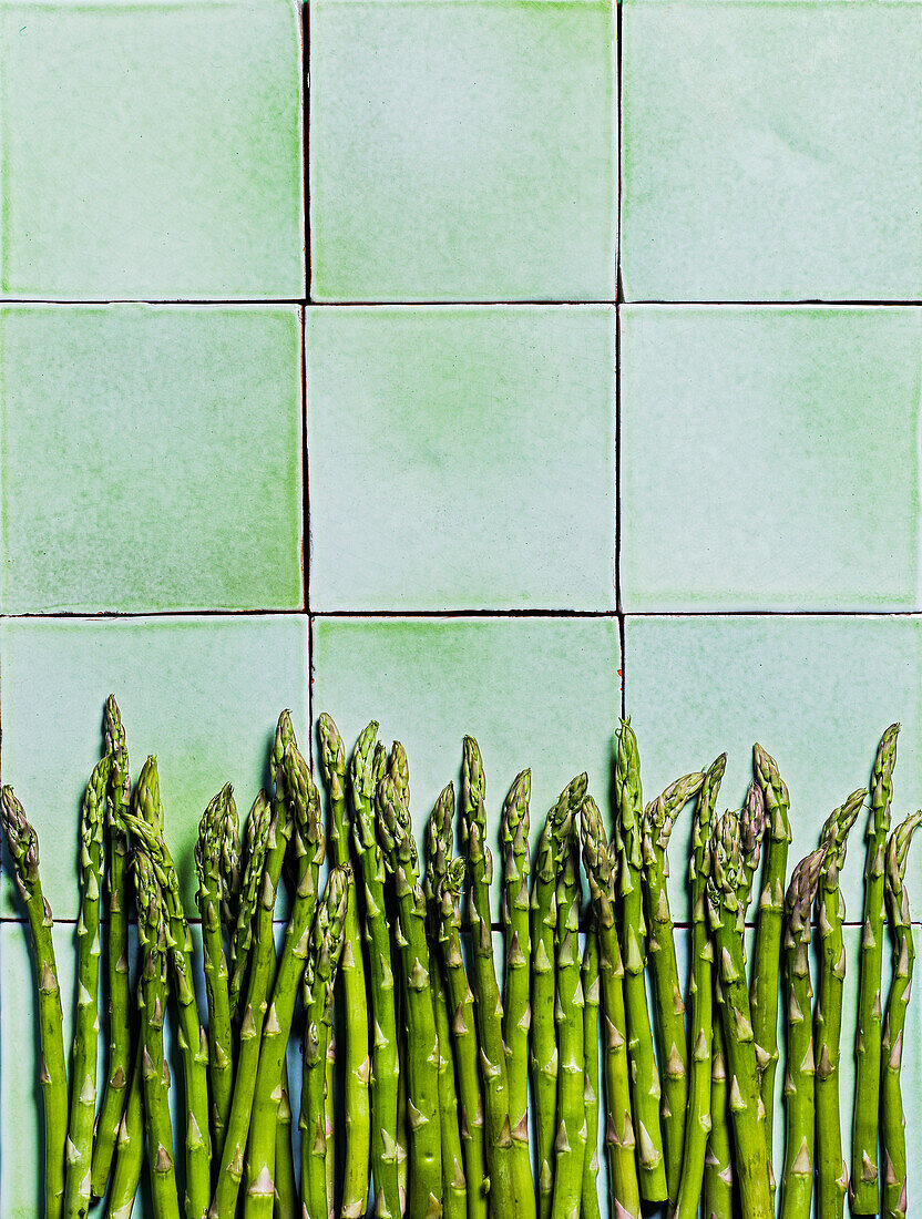 Green asparagus on tiles