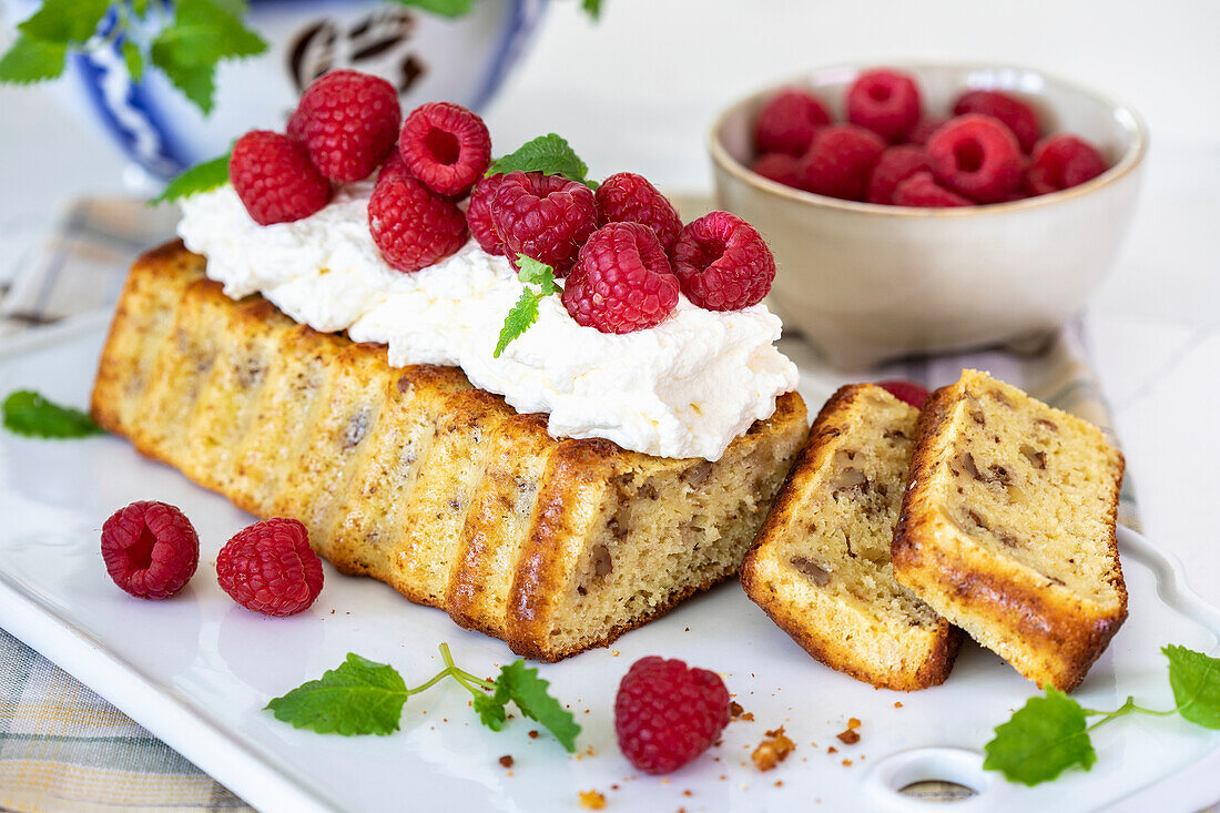 Date cake with cream and fresh raspberries