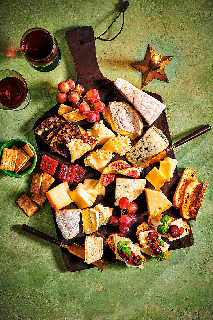 Cheese platter with fruit and red wine