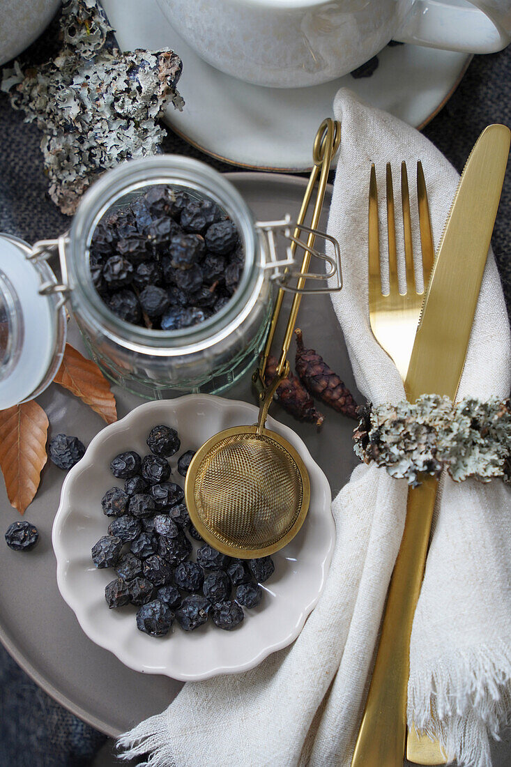 Stillleben mit getrockneten Schlehenbeeren und Teeei