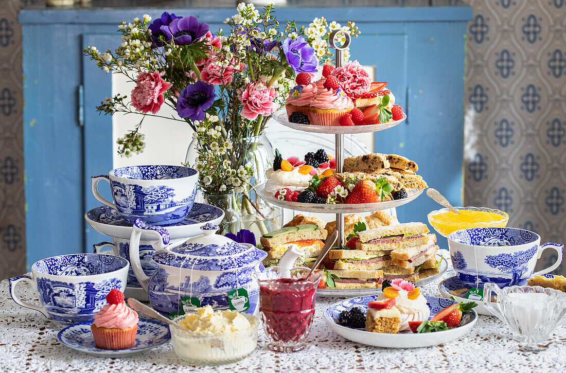 High tea with sweet pastries and sandwiches