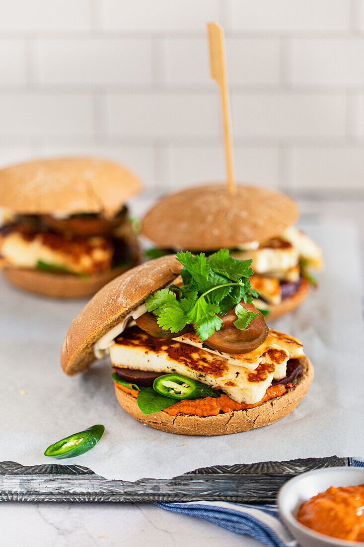 Veggie burger with fried halloumi and muhammara sauce