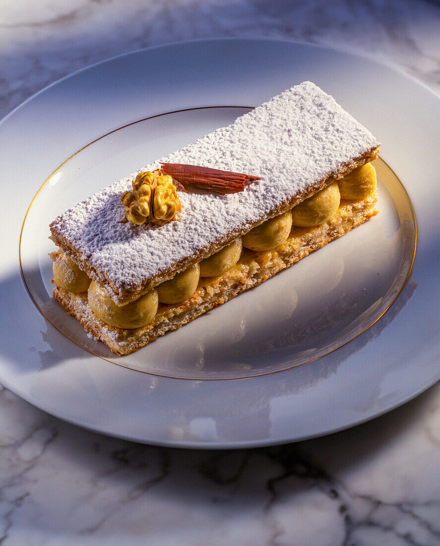 Dacquoise with nut cream and icing sugar