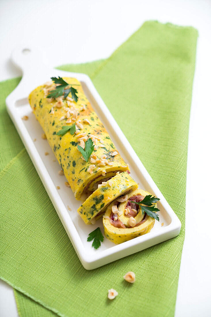 Baked omelette roulade with salmon and hazelnuts
