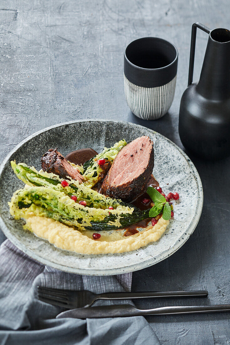 Veal fillet in a cardamom and cocoa coating with pomegranate and mint sauce