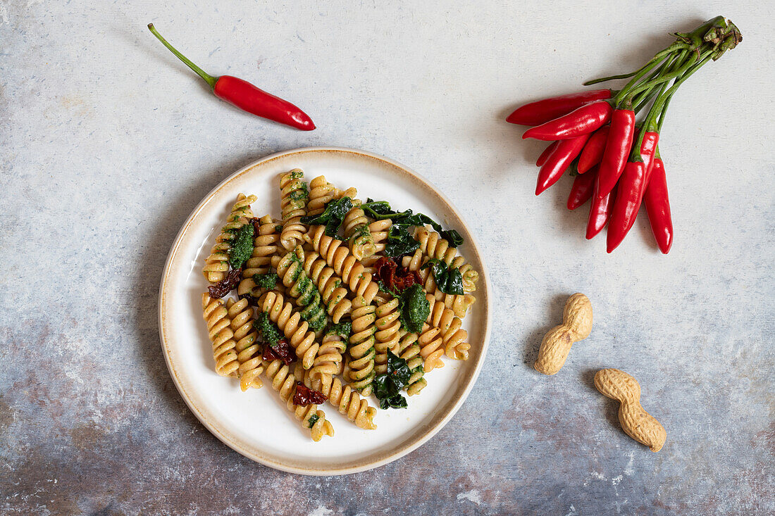 Fusilli with black cabbage and peanut pesto and sun-dried tomatoes