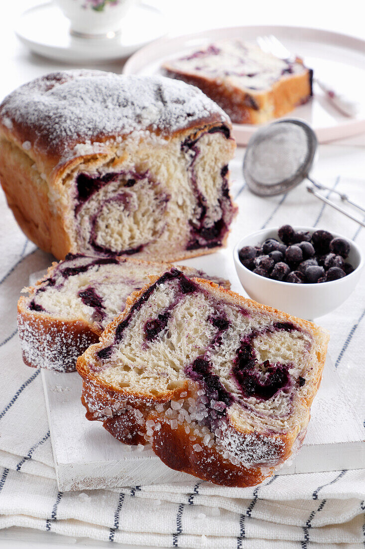 Yeast plait with blueberry filling and icing sugar