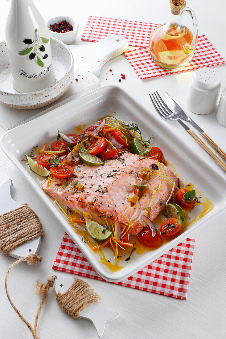 Oven-baked salmon fillet with cherry tomatoes and lime