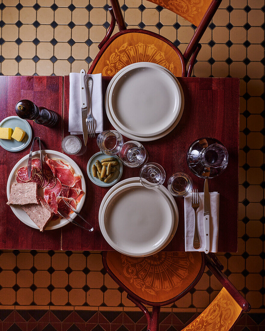 Table setting with bistro-style sausage and ham platter