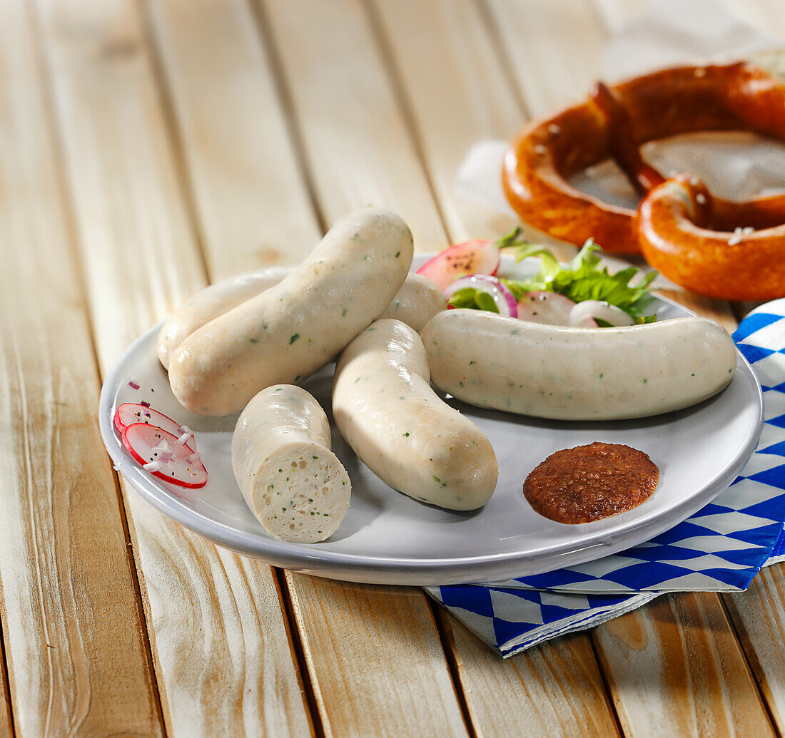 White sausages with sweet mustard, radish salad and pretzel
