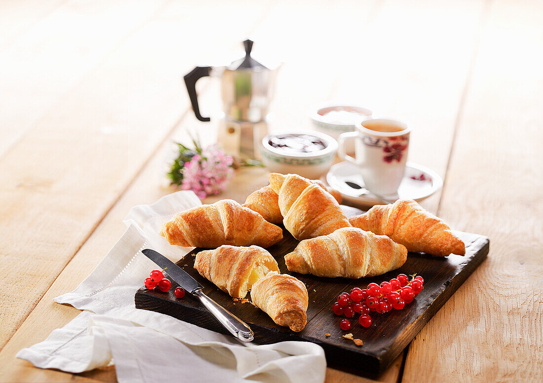 Fresh croissants with jam and espresso