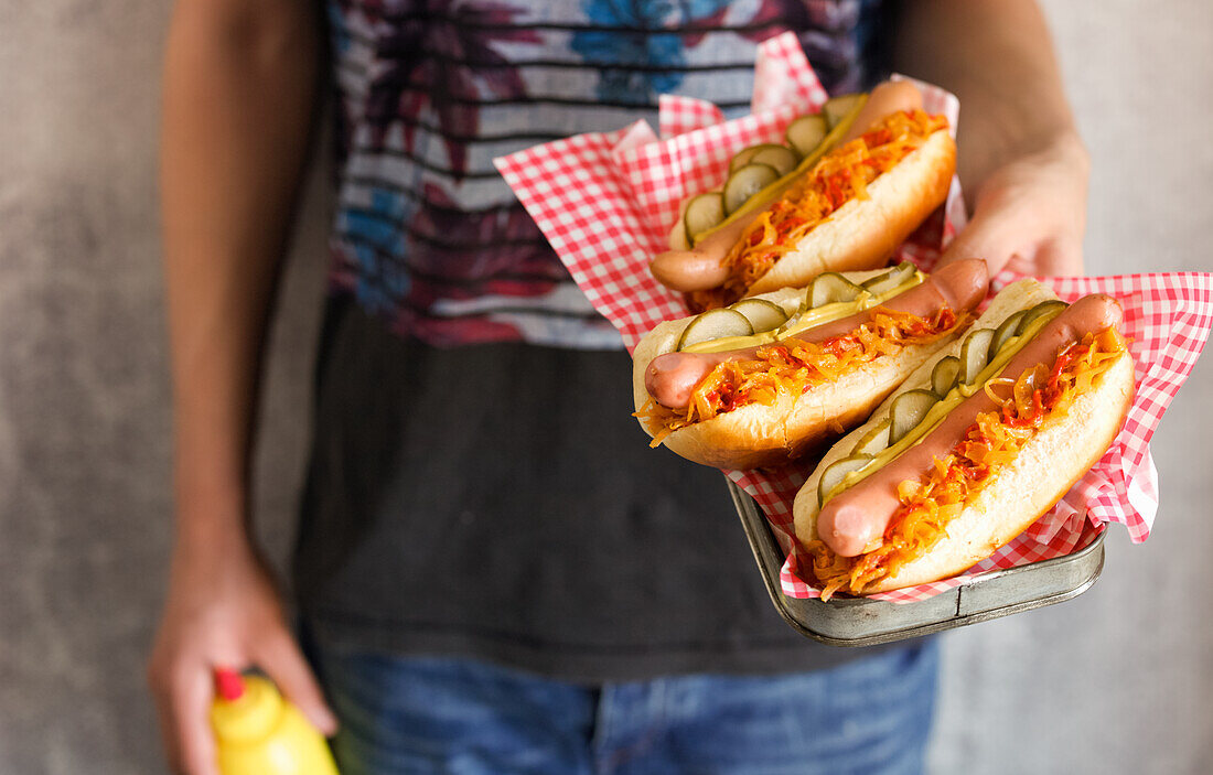 Hot dogs with fried onions and cucumber