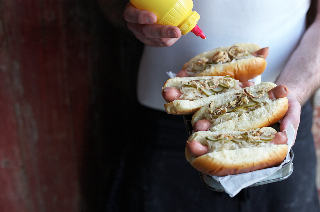 Hot dogs with sauerkraut, gherkin and fried onions