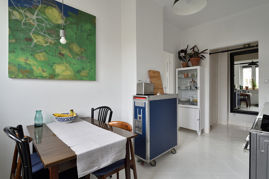 Kitchen with dining area and painting on the wall