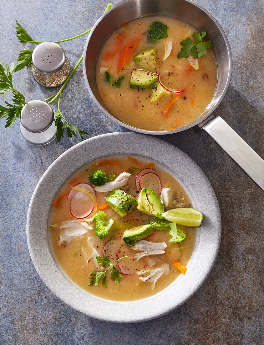 Chicken soup with avocado, radish and lime