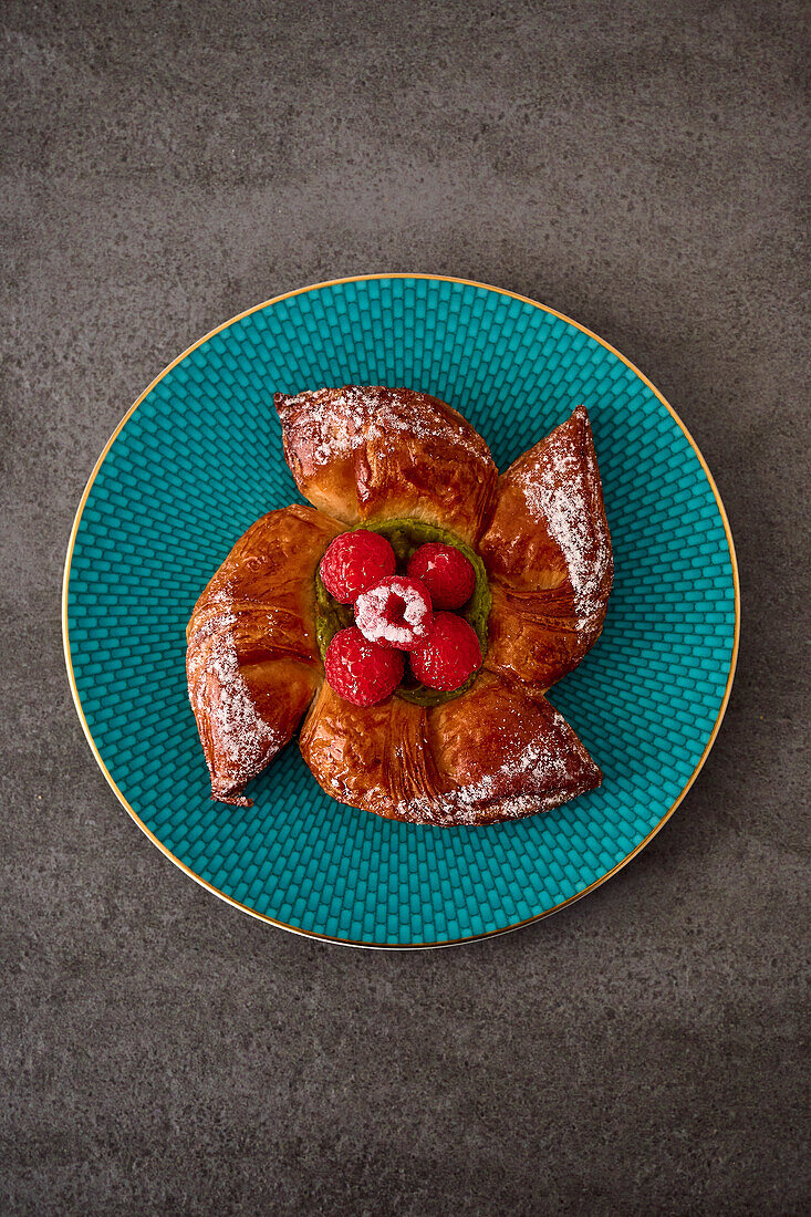 Star-shaped croissant with pistachio filling and raspberries