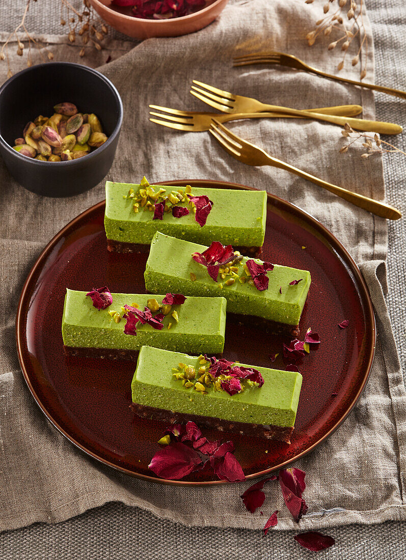 Pistachio bars with dates and coconut, decorated with rose petals