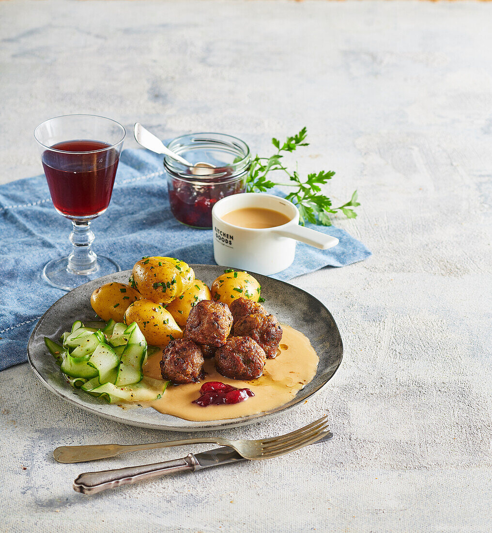 Swedish meatballs with potatoes, cucumber salad and lingonberry jam