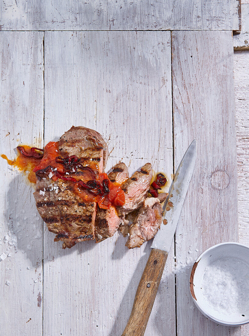 Grilled steak with chilli-tomato sauce and garlic