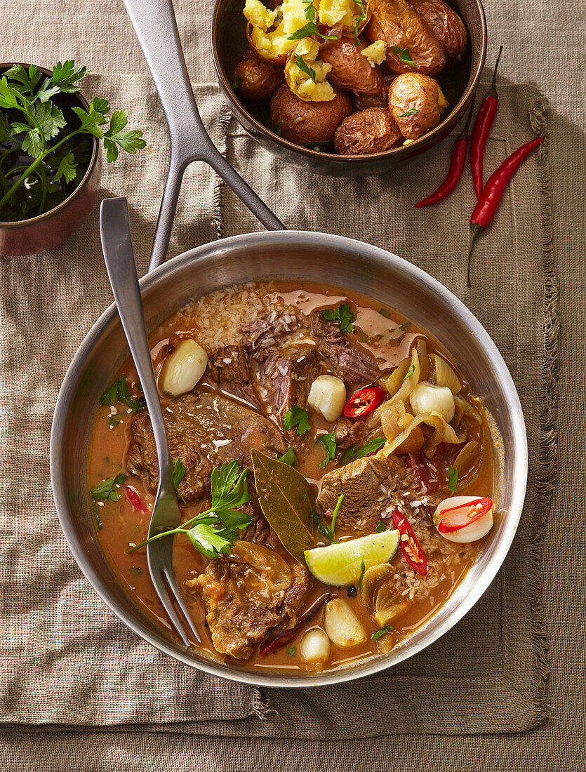 Beef curry with coconut chilli sauce and lemon wedges