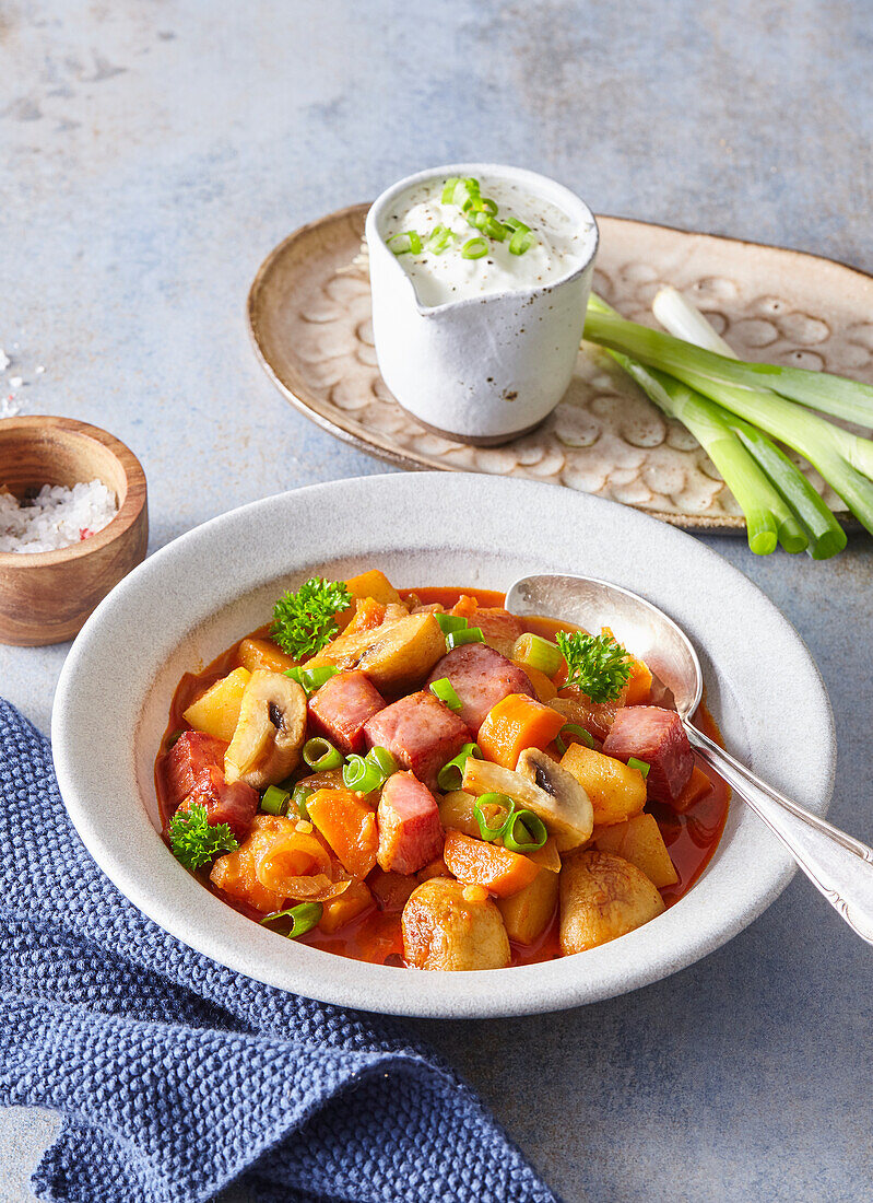 Potato and mushroom goulash with carrots and smoked meat