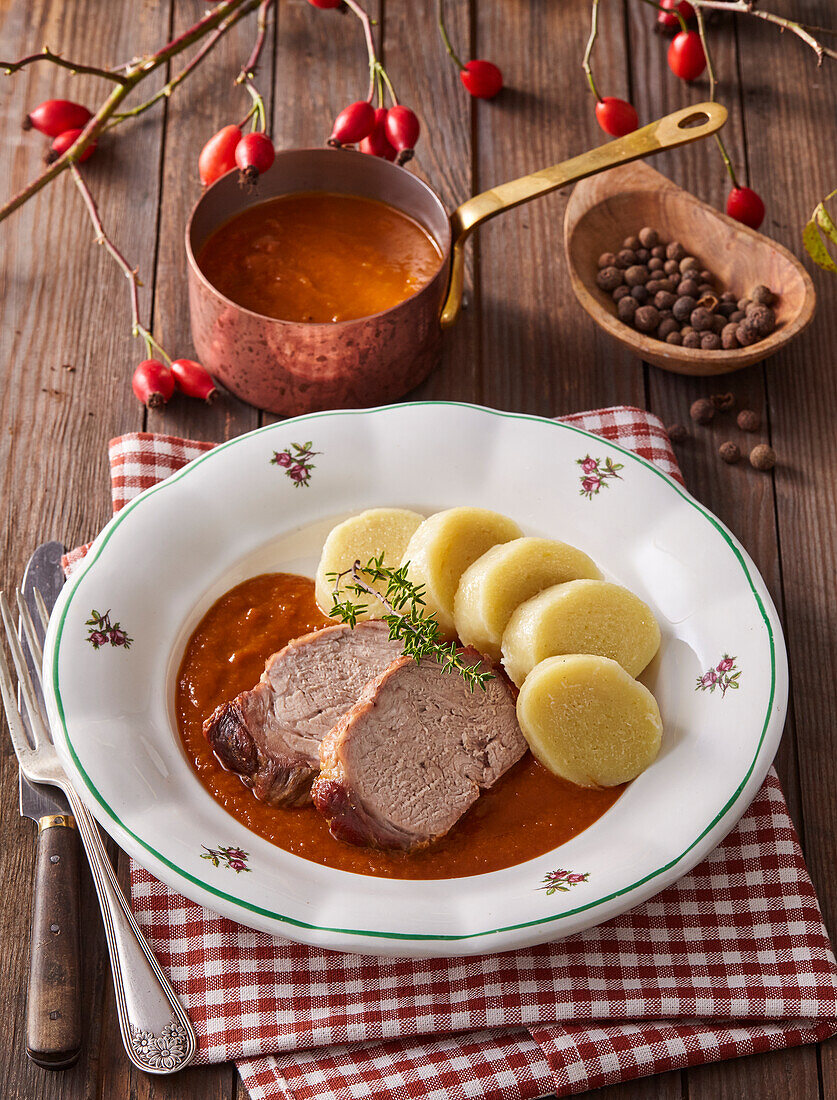 Roast wild boar with rosehip sauce and dumplings