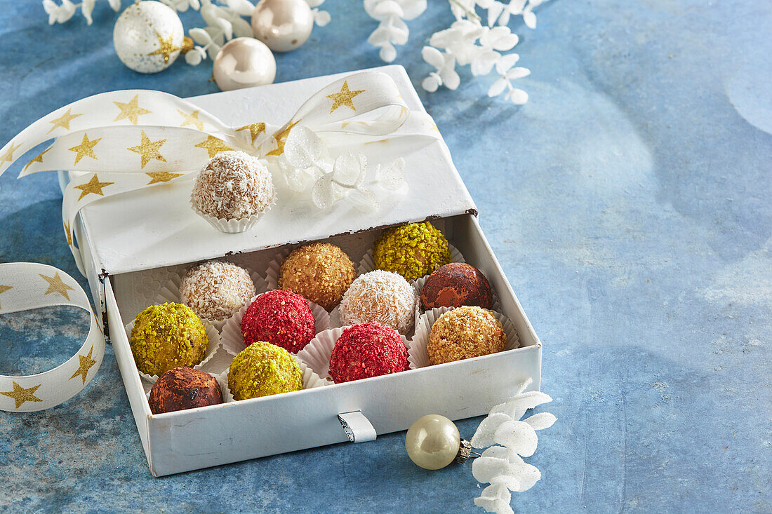 Colourful rum balls with nuts and coconut flakes