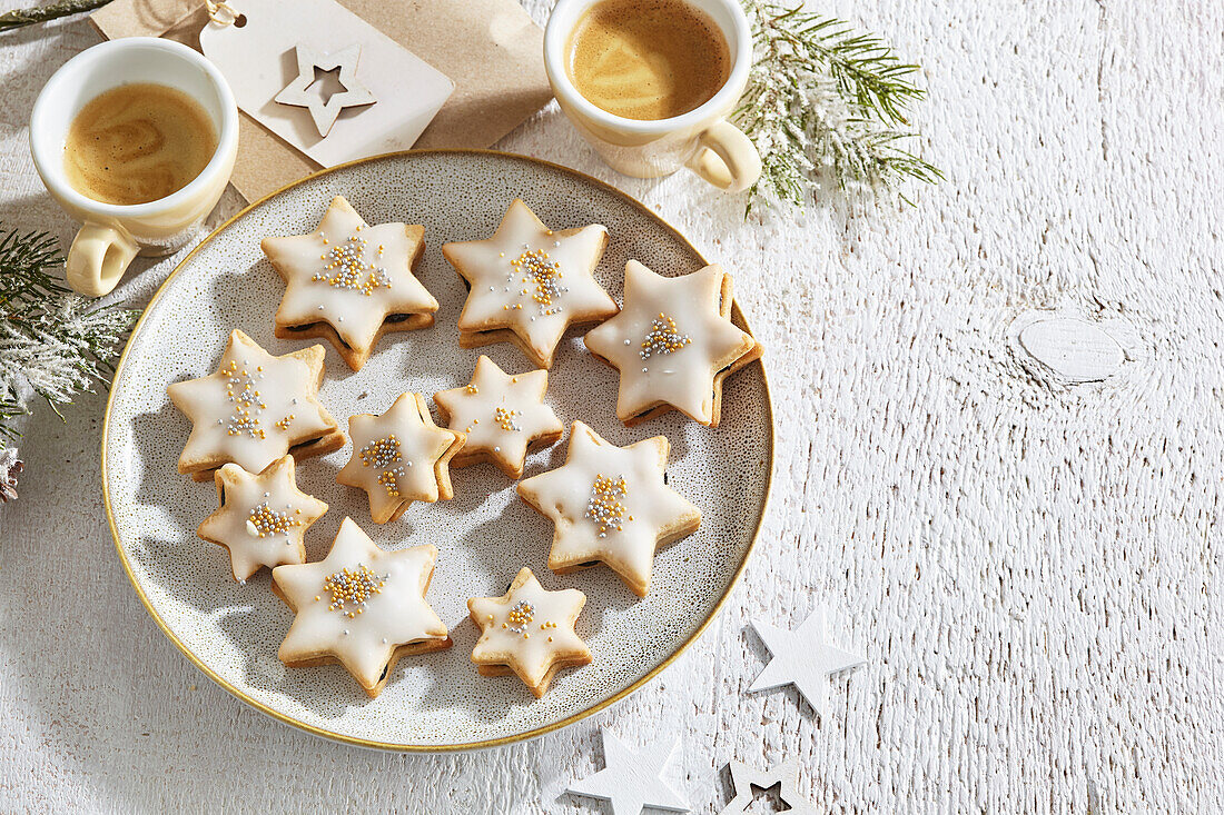 Star-shaped biscuits with plum jam filling and sugar icing