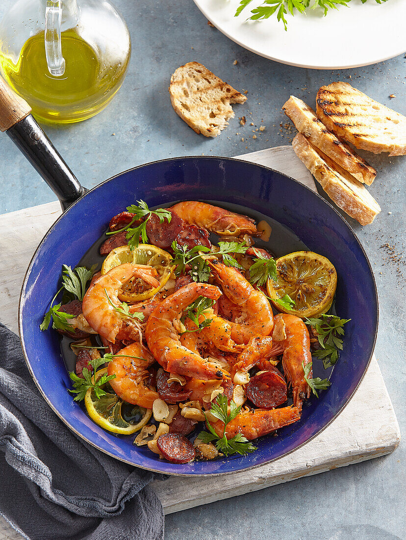 Prawns with chorizo and herbs in the pan