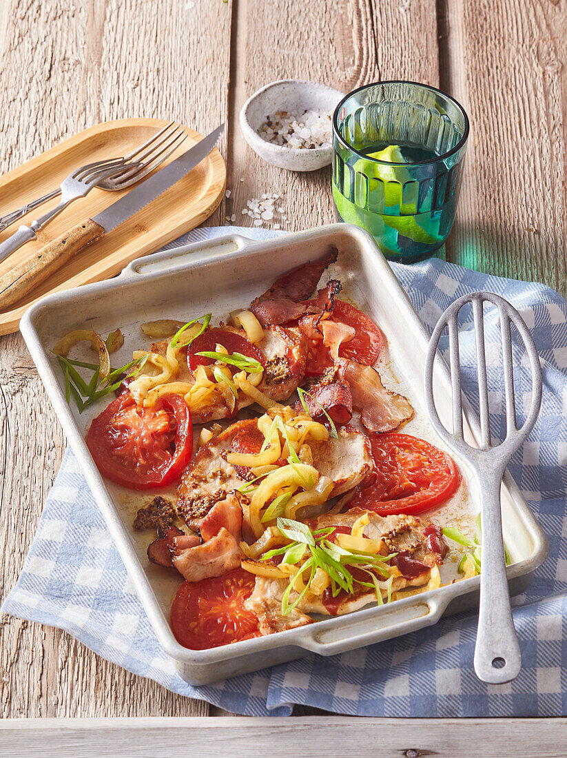 Baked pork chops with bacon and tomatoes