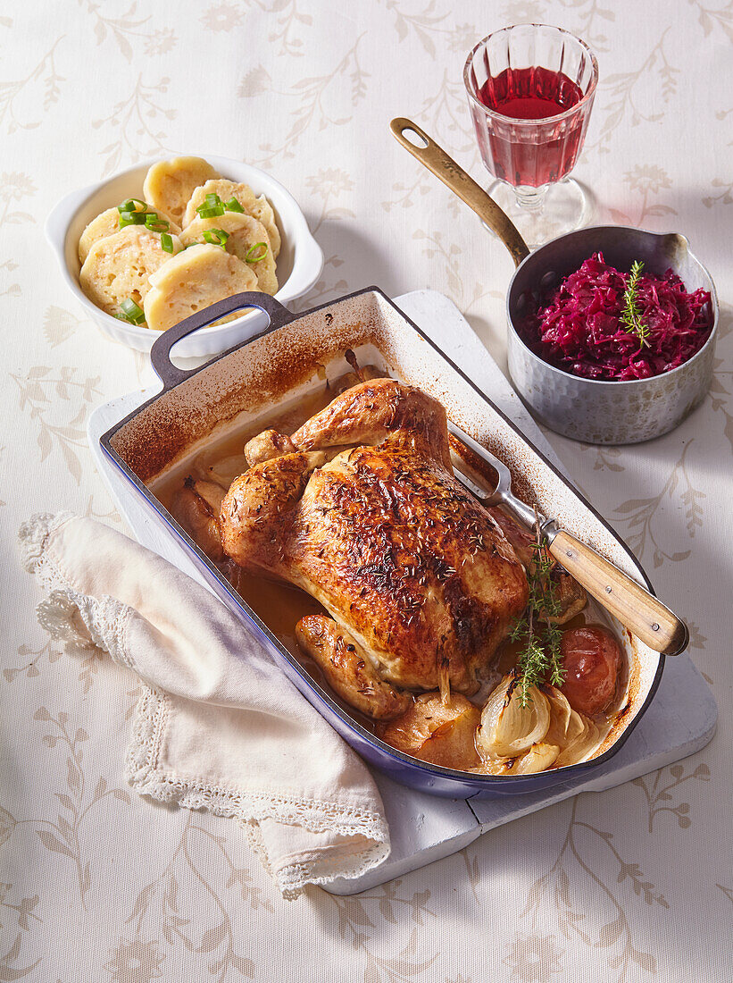 Roast chicken with apples, dumplings and red cabbage