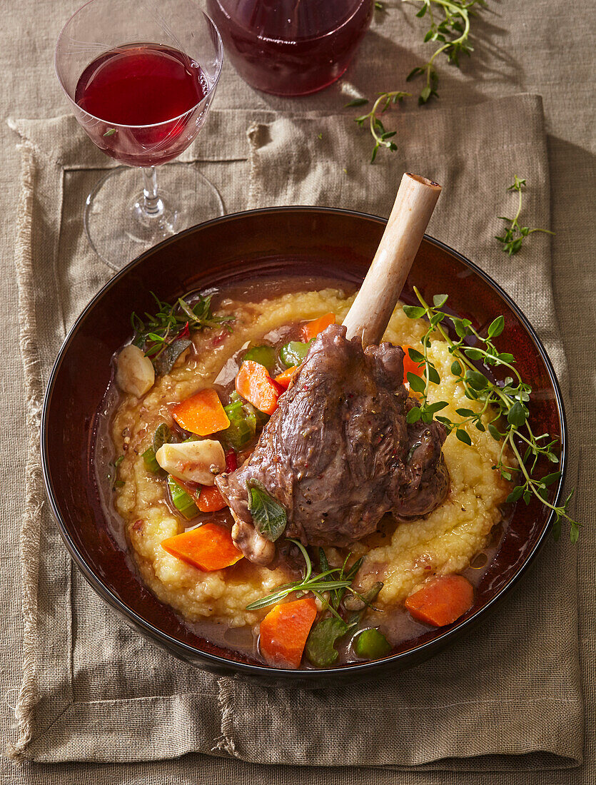 Braised lamb in red wine with carrots and herbs