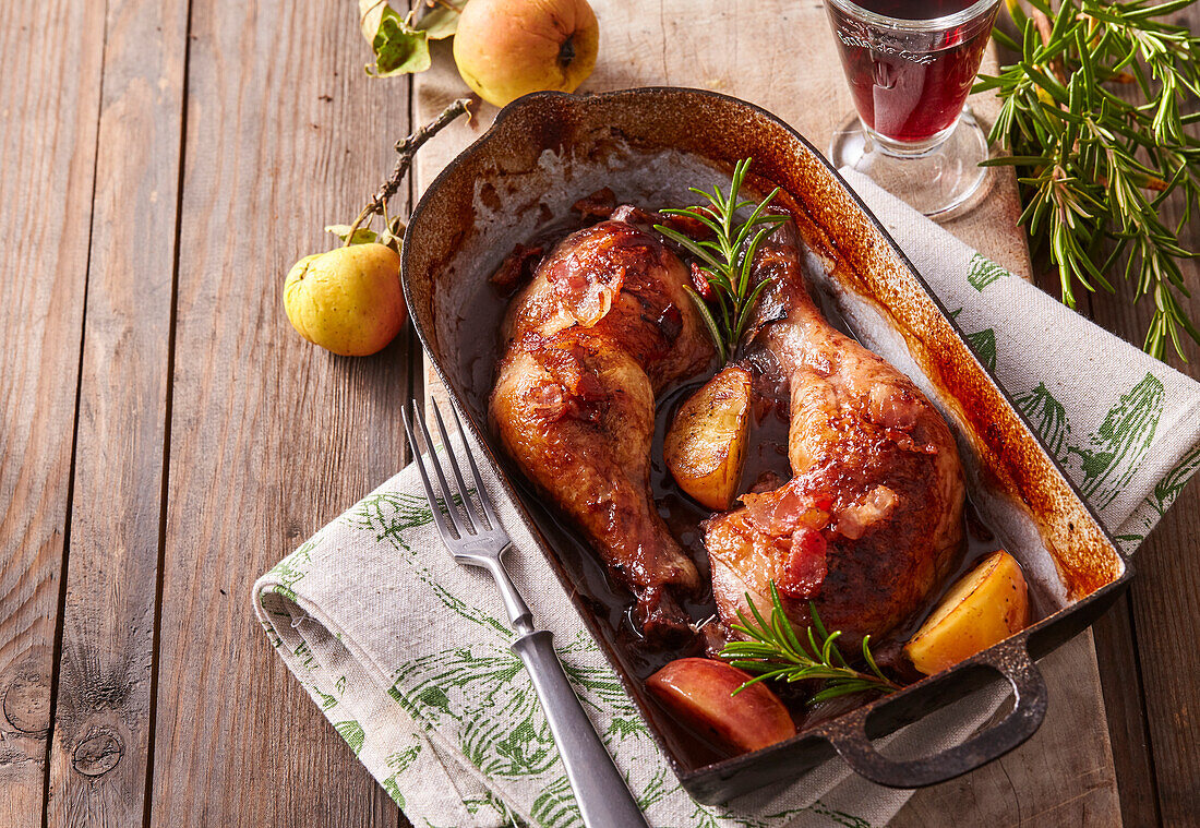 Pheasant in red wine with apples, bacon and rosemary