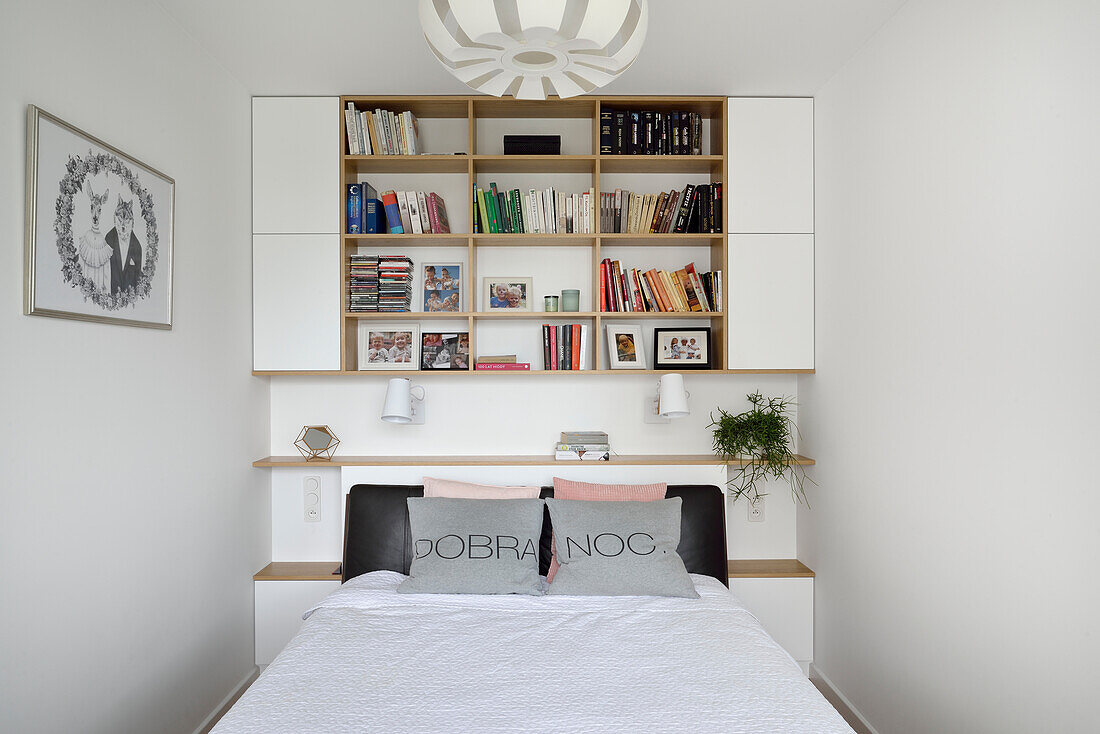 Bedroom with bookshelf and pillows with lettering