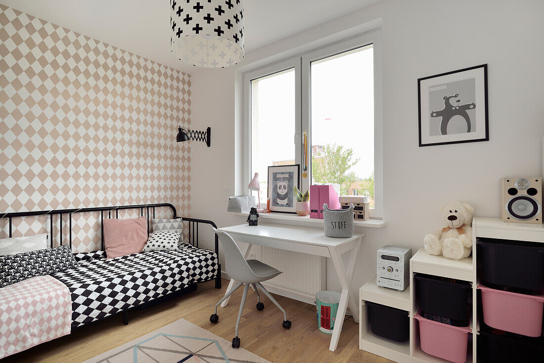 Children's room with checkered wallpaper pattern and black and white bed linen