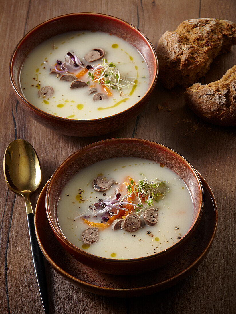 Cream of potato soup with goose meat and vegetables