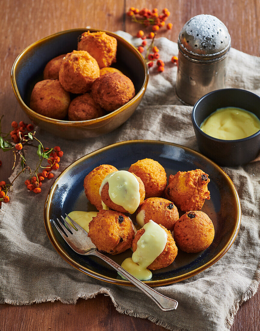 Baked potato dumplings with vanilla sauce and sultanas