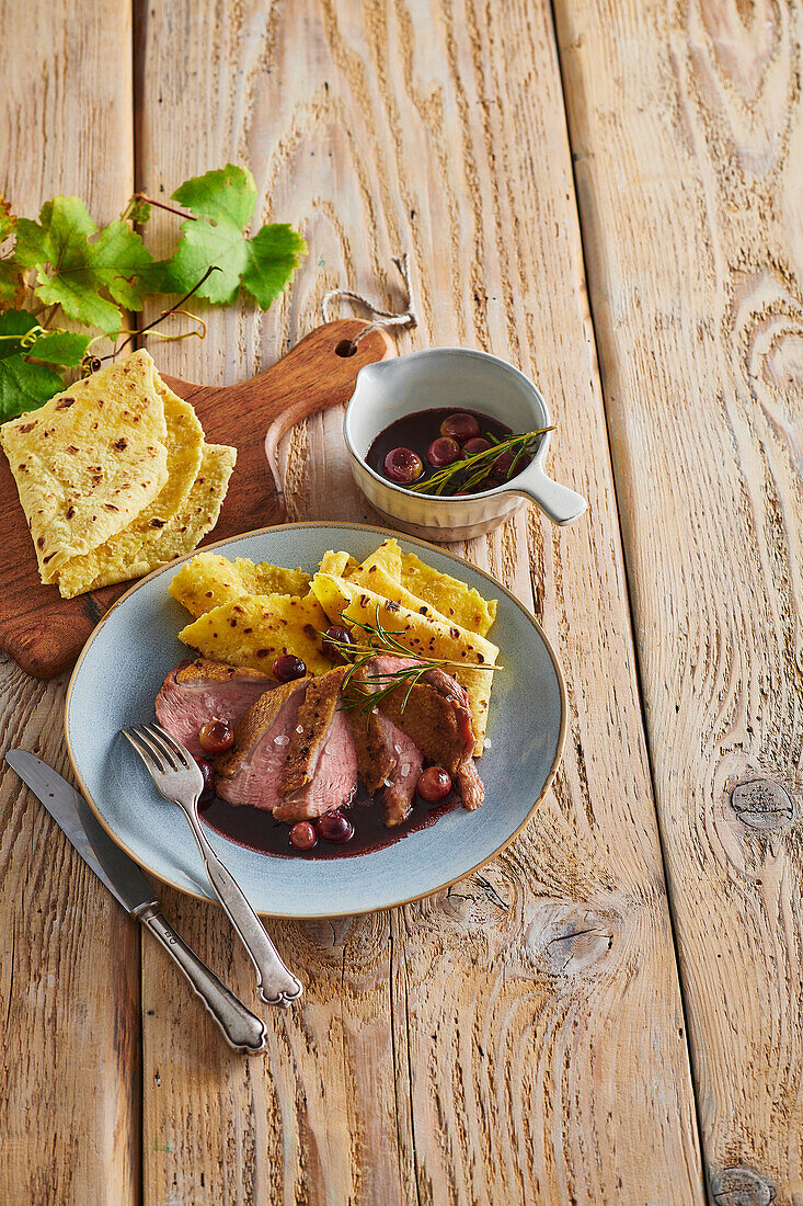 Duck breast with red wine sauce and polenta pancakes