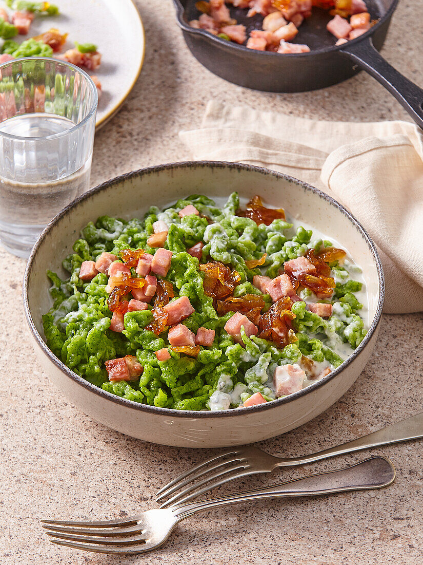 Spinach spaetzle with blue cheese sauce and bacon cubes