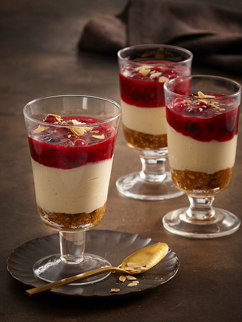 Cheesecake in a glass with biscuit base and forest fruit topping