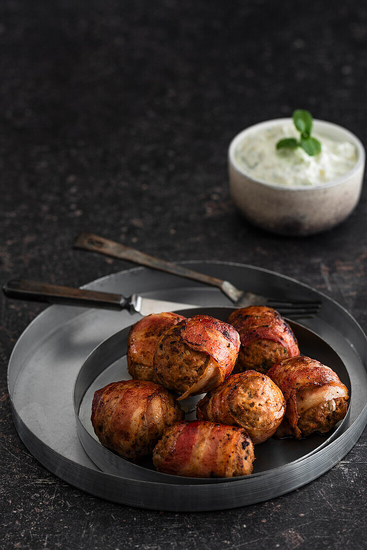 Meatballs wrapped in bacon with dip